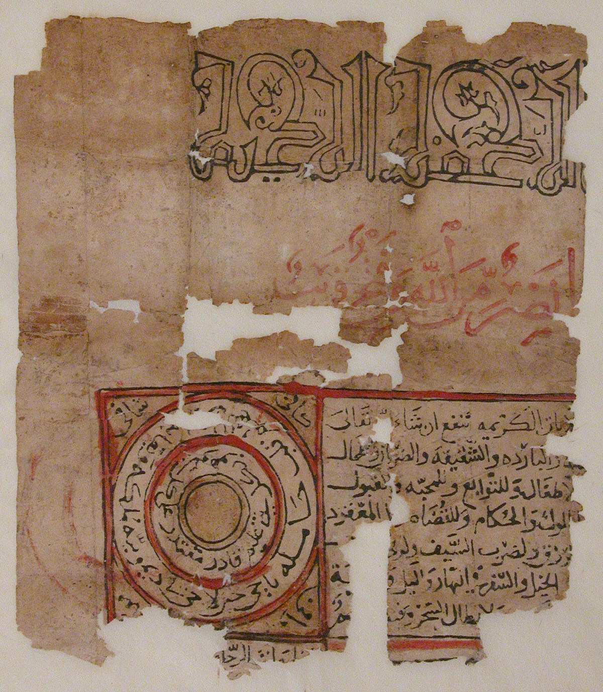 Fragment from an Arabic script manuscript, identified as a talismanic scroll. Some of the text is displayed in a circular pattern on the bottom left.